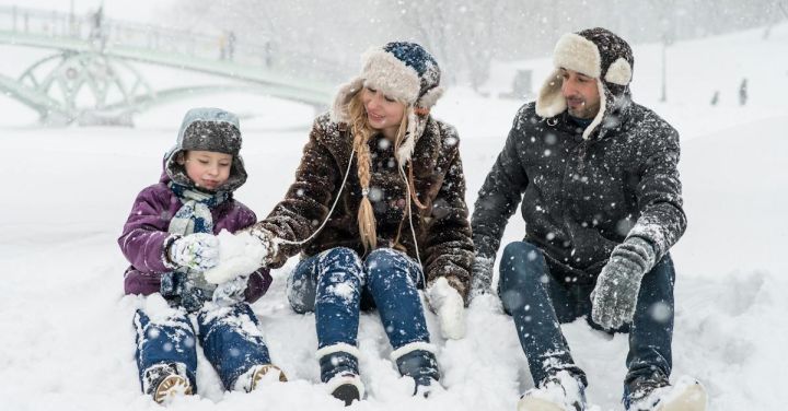 Family Fun - Woman, Man and Girl Sitting on Snow