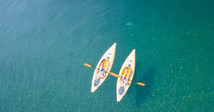 Relaxation Spots - Bird's Eye View of Two People Canoeing on Body of Water