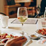Dining Out - Wine in Clear Glass Near Food on Plate on Table