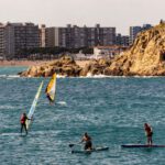 Water Activities - People Using Paddle Boards in the Sea