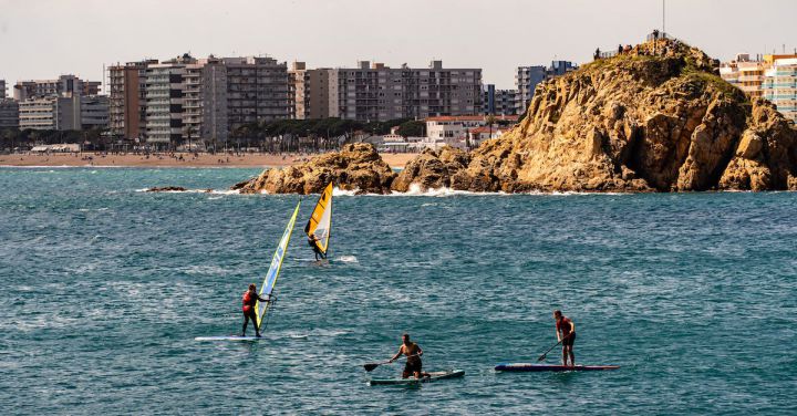 Water Activities - People Using Paddle Boards in the Sea